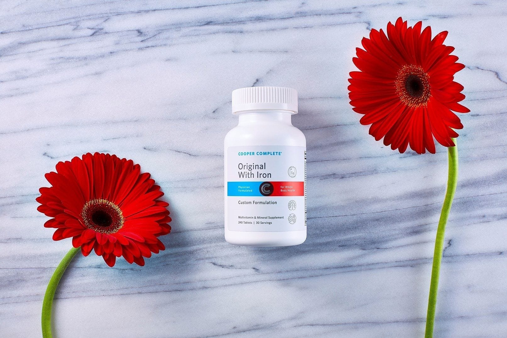Cooper Complete Original with Iron Multivitamin and Mineral Formulation bottle with red flowers