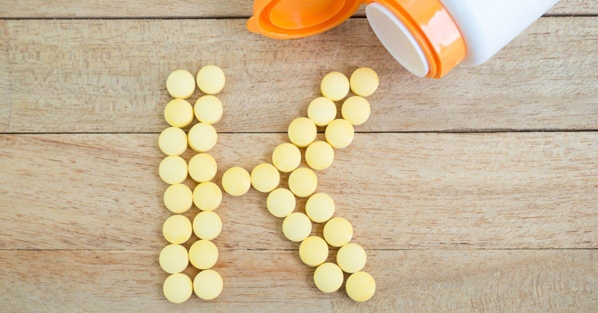 Vitamin k supplement tablets in the shape of a k