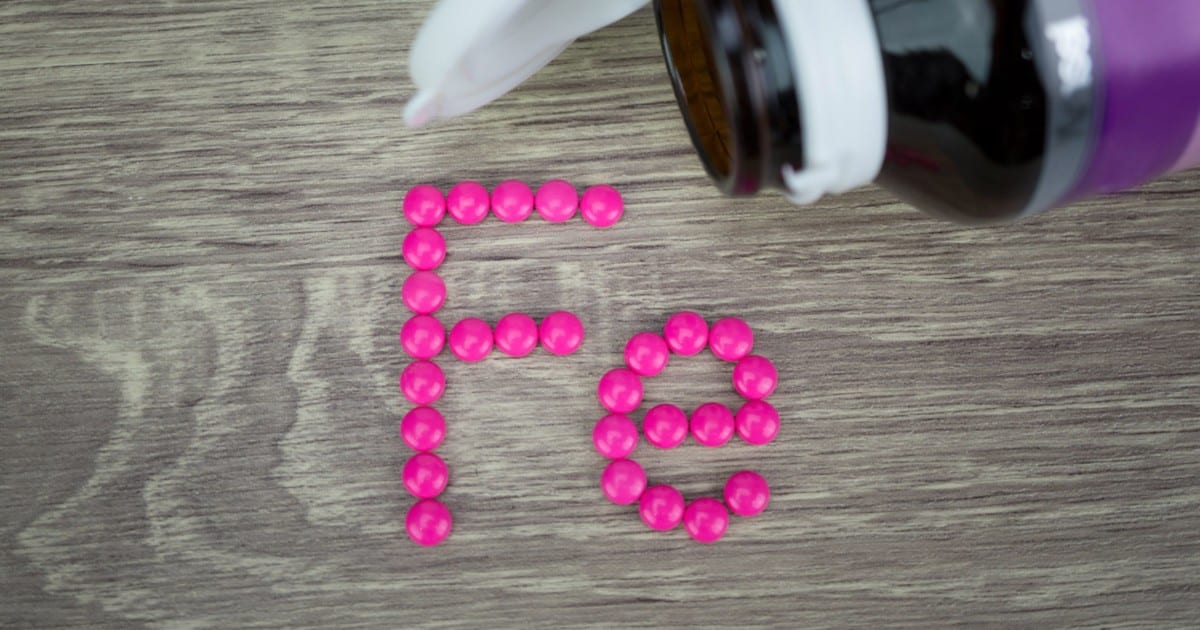 iron supplement tablets arranged to show elemental symbol of iron