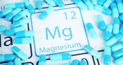 magnesium supplements around a magnesium paper