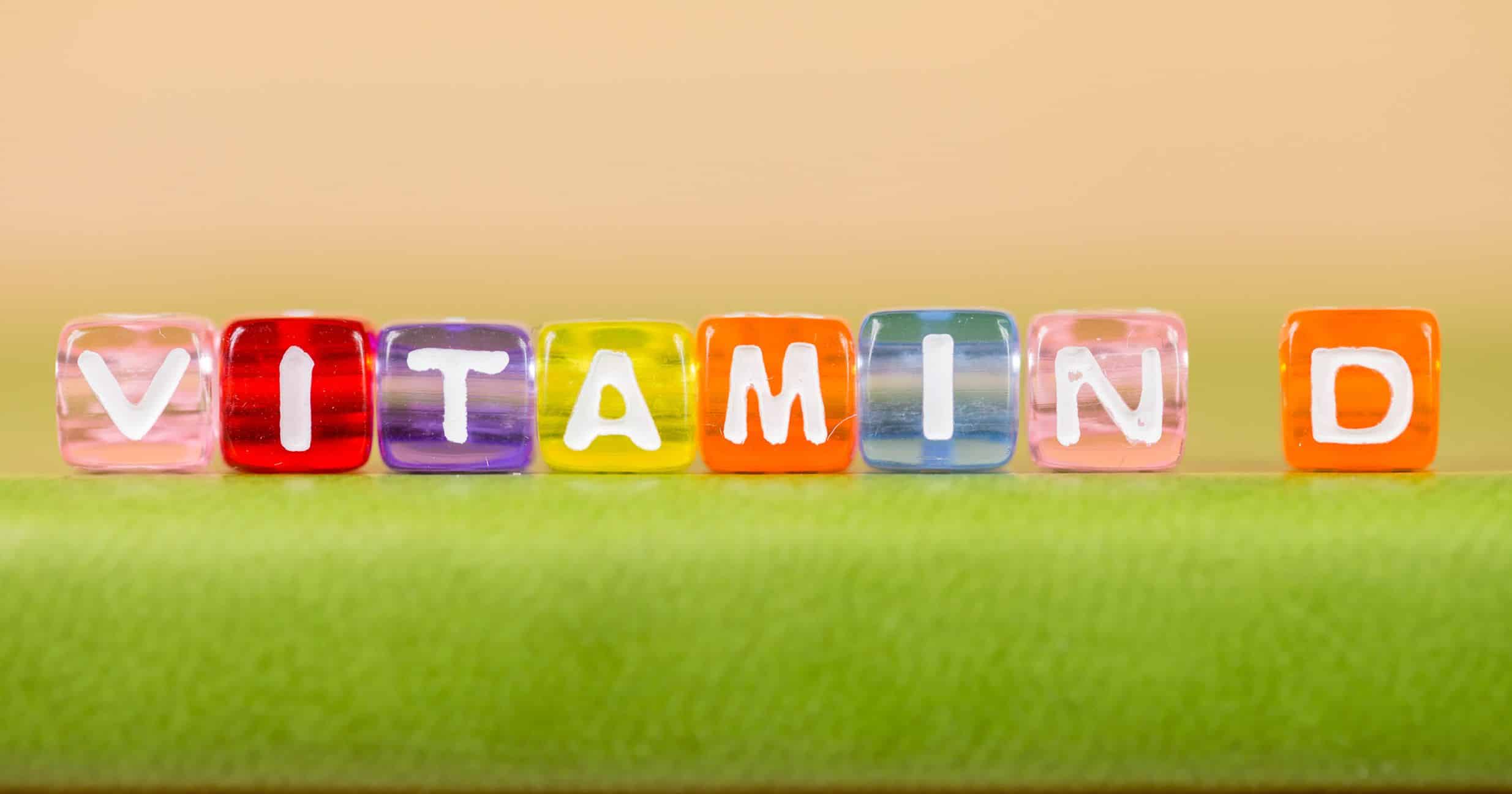 Vitamins spelled out with colored cubes