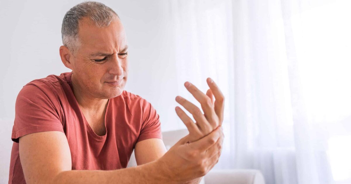 Arthritis symptoms bothering hand of a man